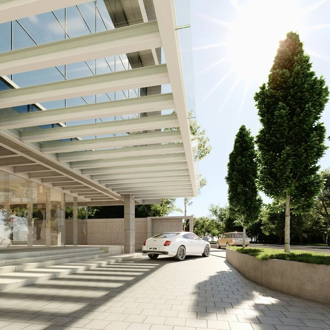 Modern white car parked outside a glass building with a white canopy and tall trees in bright sunlight