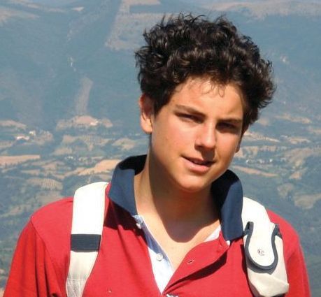 Blessed Carlo Acutis in a red shirt with a backpack on his back