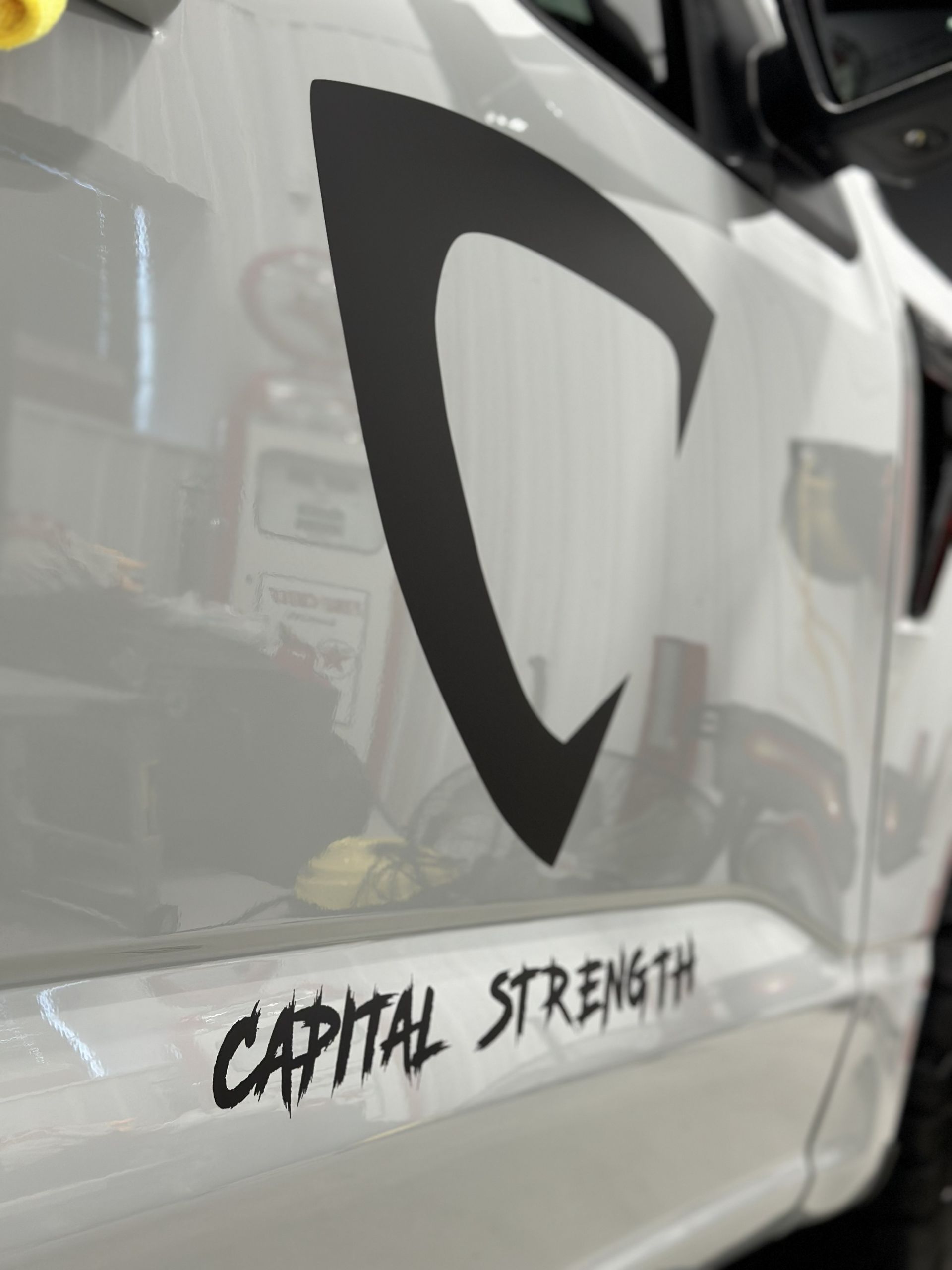 White truck side with black logo and the words “Capital Strength” near the bottom.