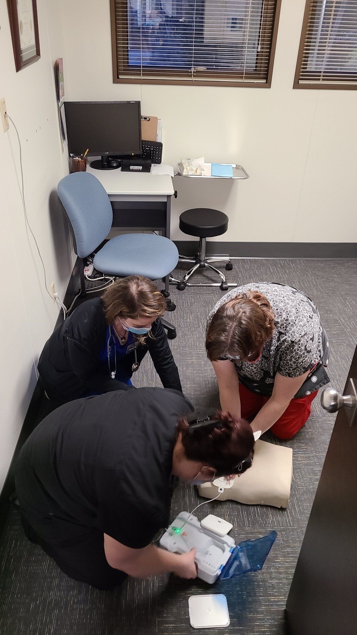 A group of people are kneeling on the floor in a room.