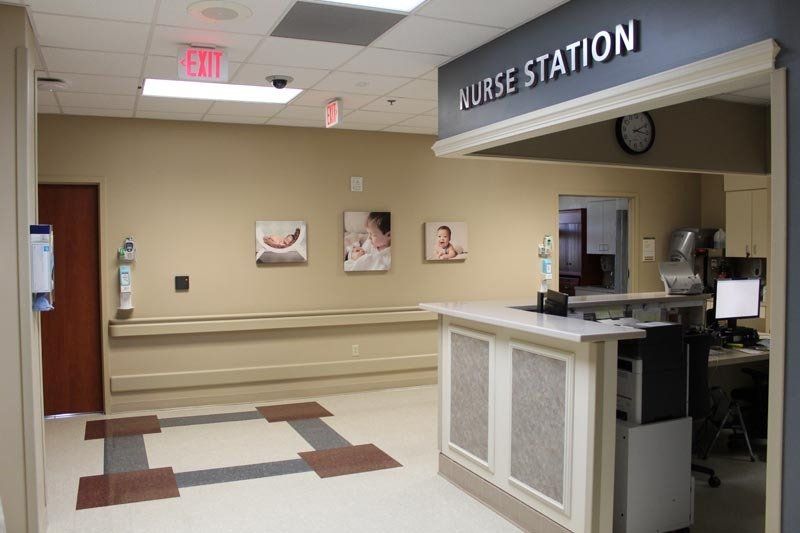 A nurse station in a hospital with a clock on the wall