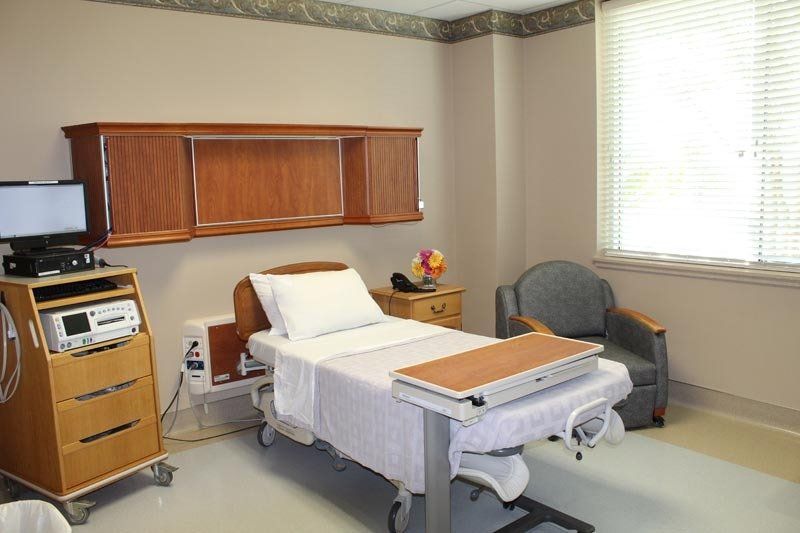 A hospital room with a bed and a table