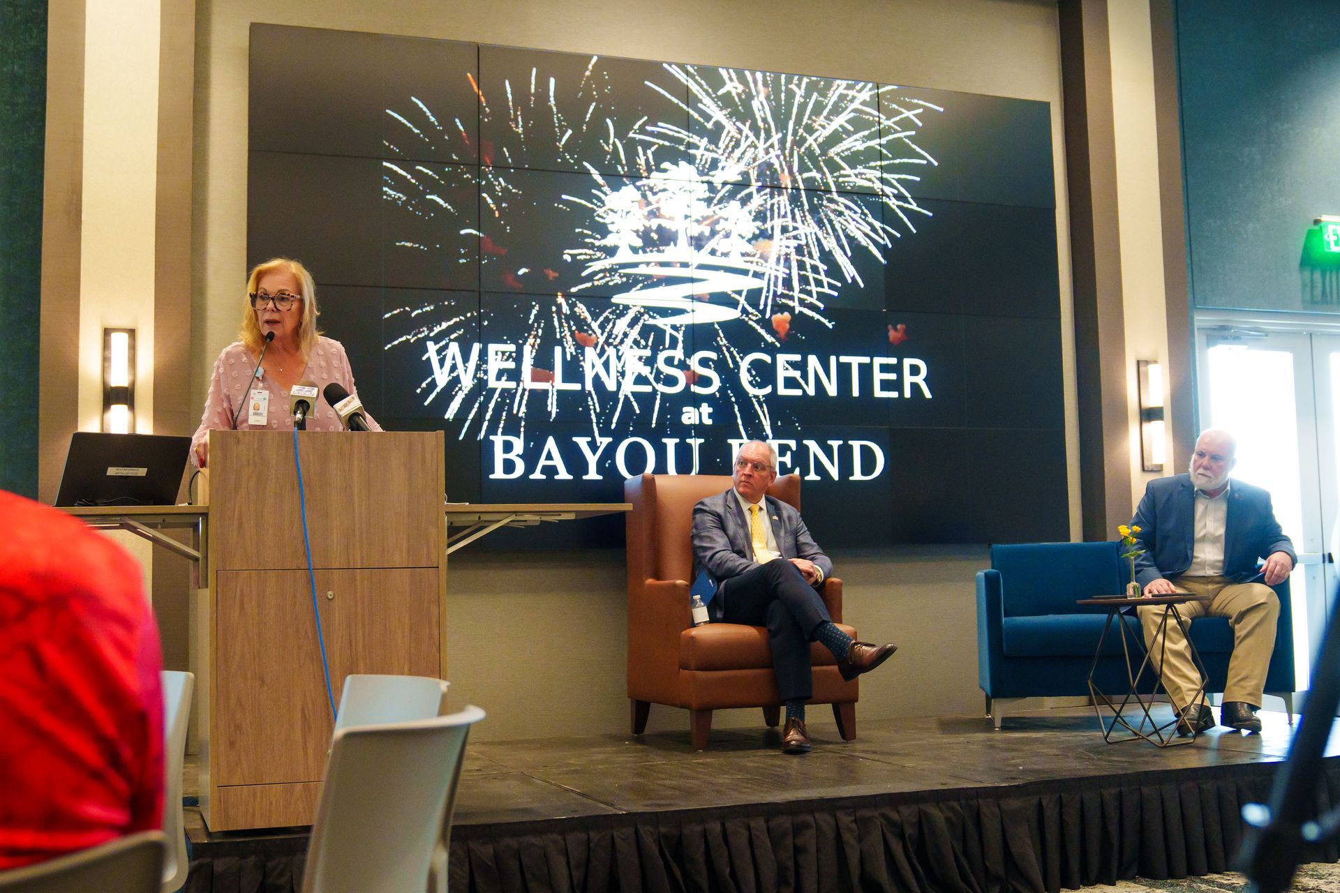 A woman is giving a presentation at the wellness center at bayou end.