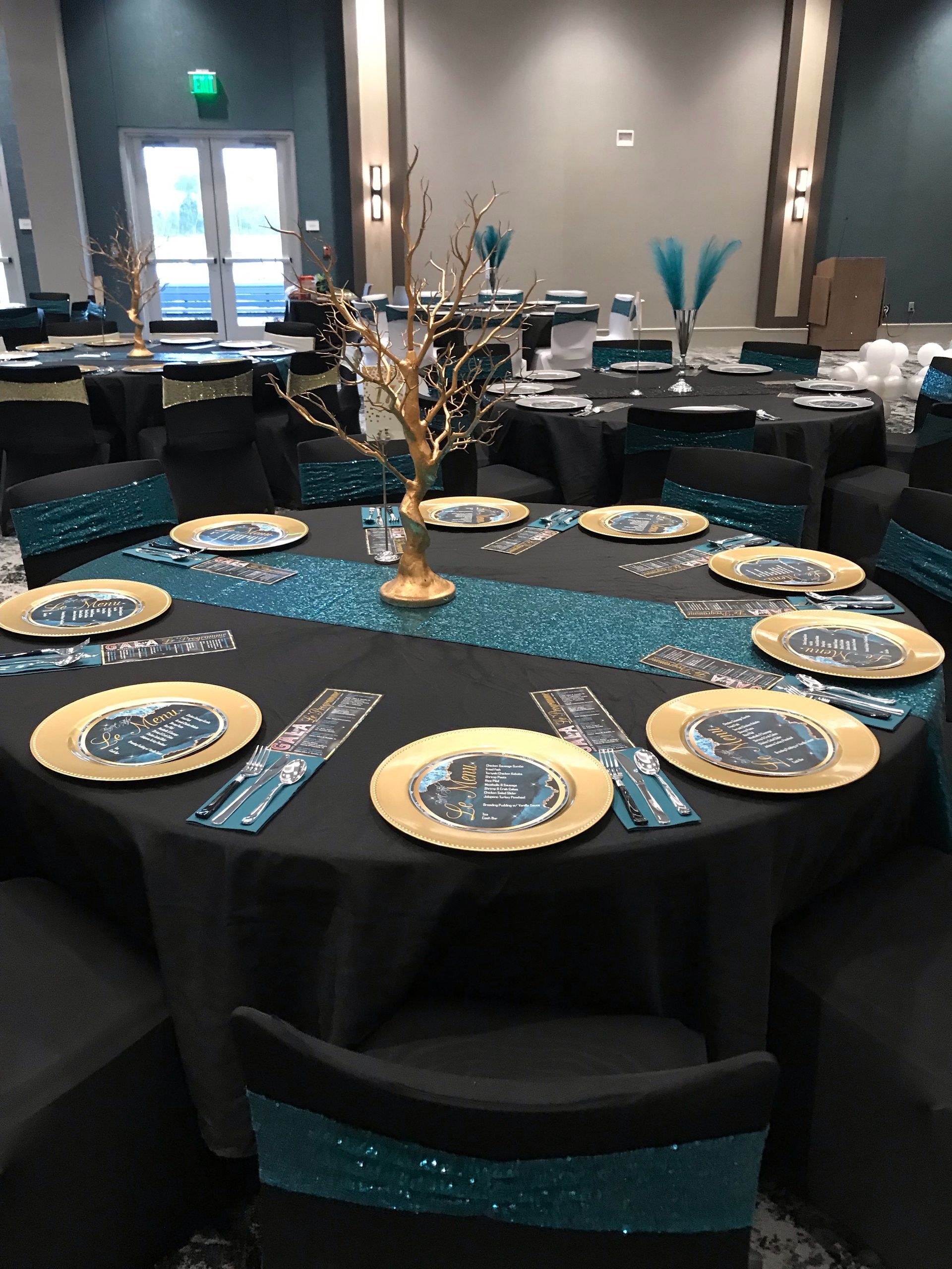 A large room with tables and chairs set up for a party.