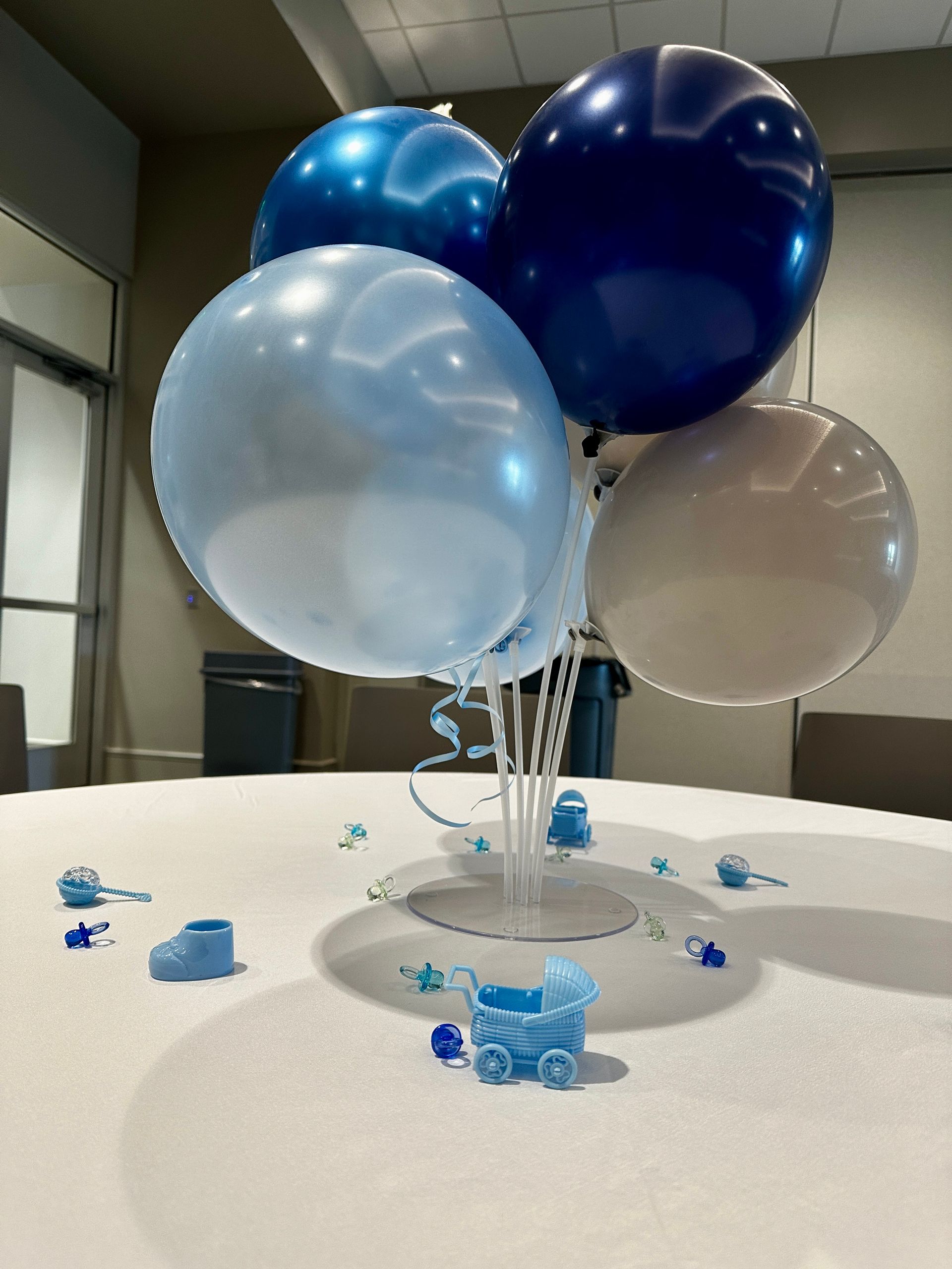 A bunch of blue and white balloons on a table