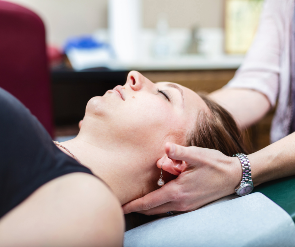 A woman is getting a neck massage from a doctor.