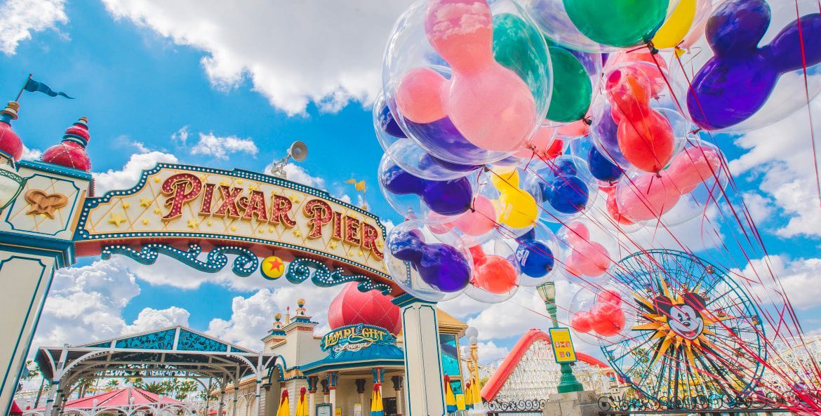 Colorful balloons floating above the Santa Fe amusement park entrance on a bright day