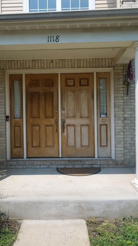 Front porch with double wooden front doors and house number 1118 above the entrance.