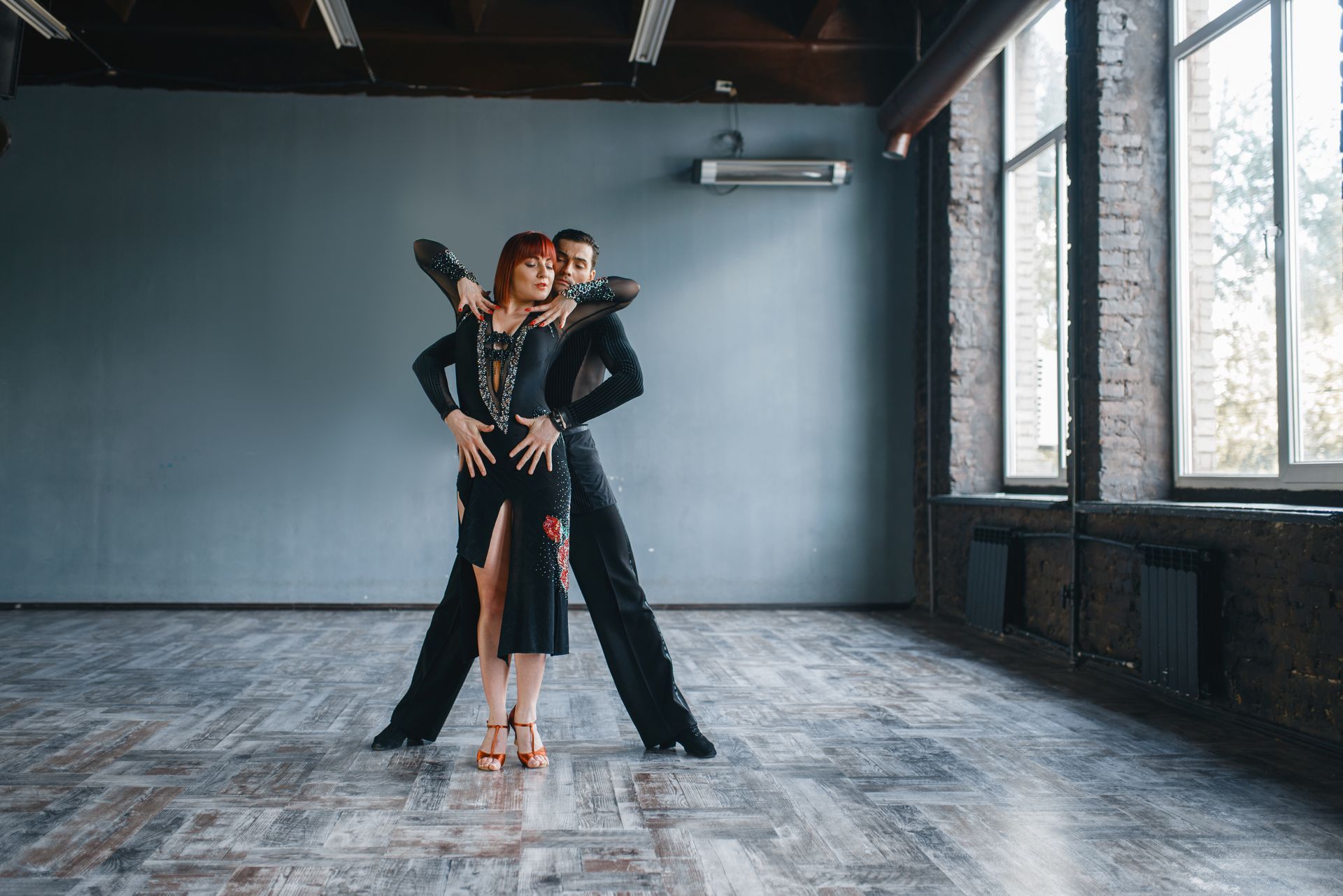 Professional ballroom dance classes featuring a couple performing an elegant partner dance routine.