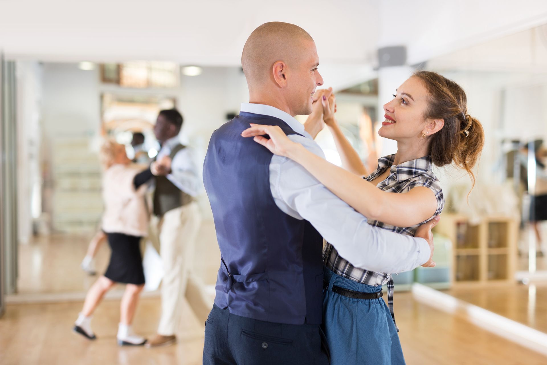 Happy man and woman enjoying a ballroom dance together