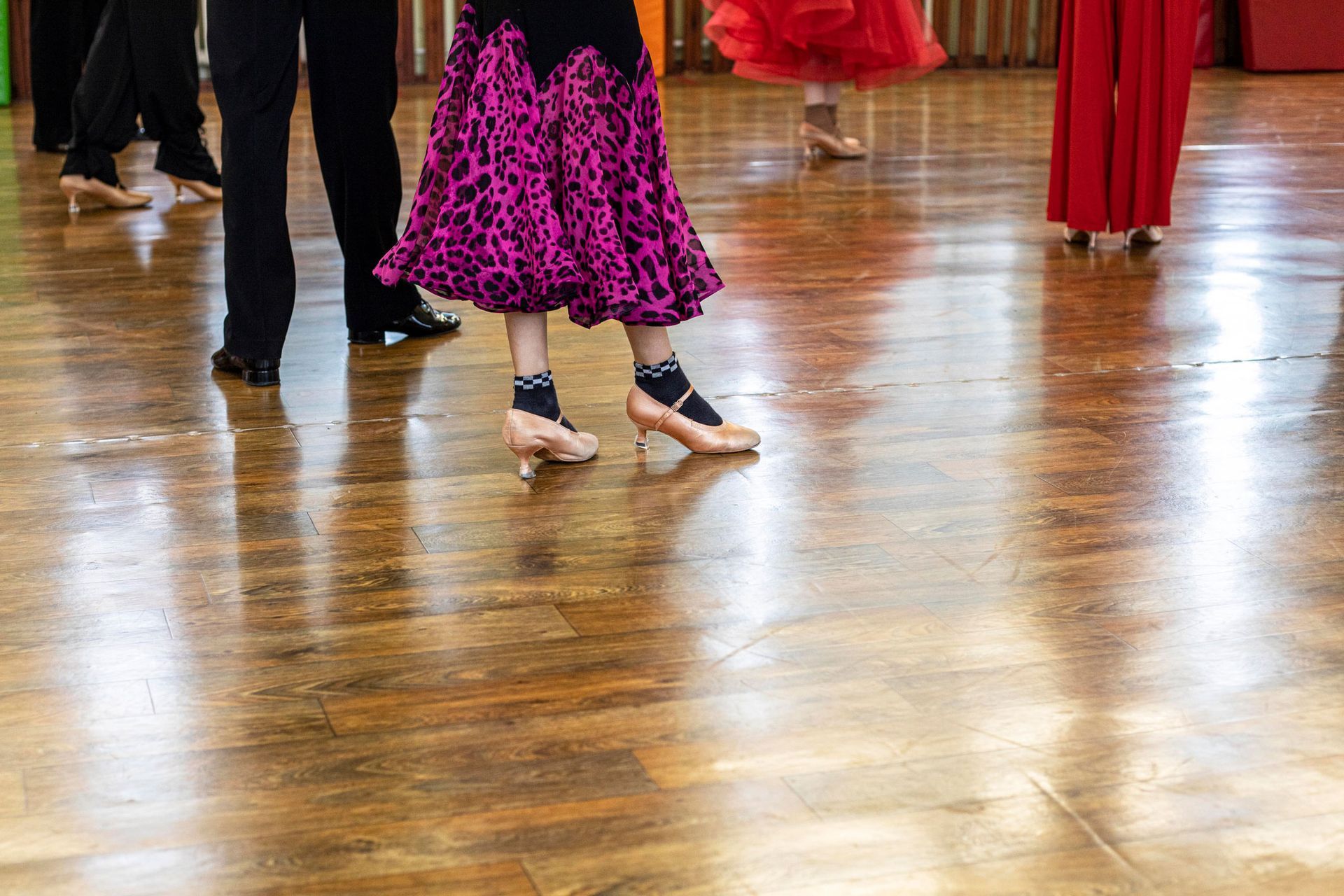 People having a group dance lesson in a professional studio.