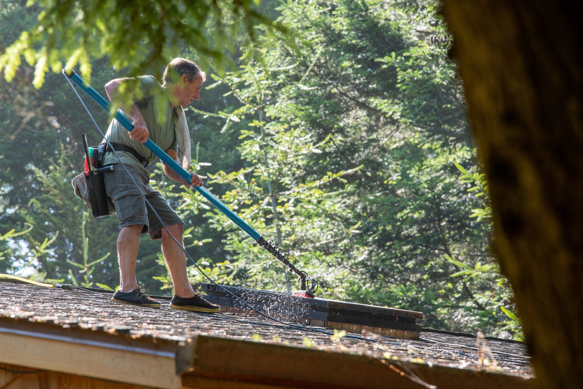 Man Cleaning Roof With Pressure Washing — Clanton, AL — Pristine Power Clean Man Cleaning Roof With Pressure Washing — Clanton, AL — Pristine Power Clean