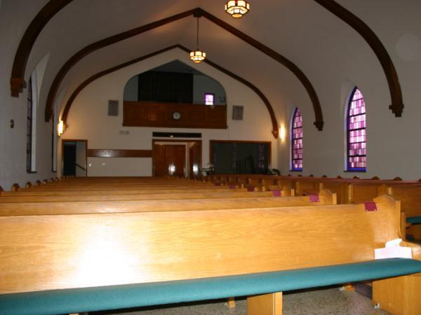 A church with wooden benches and stained glass windows