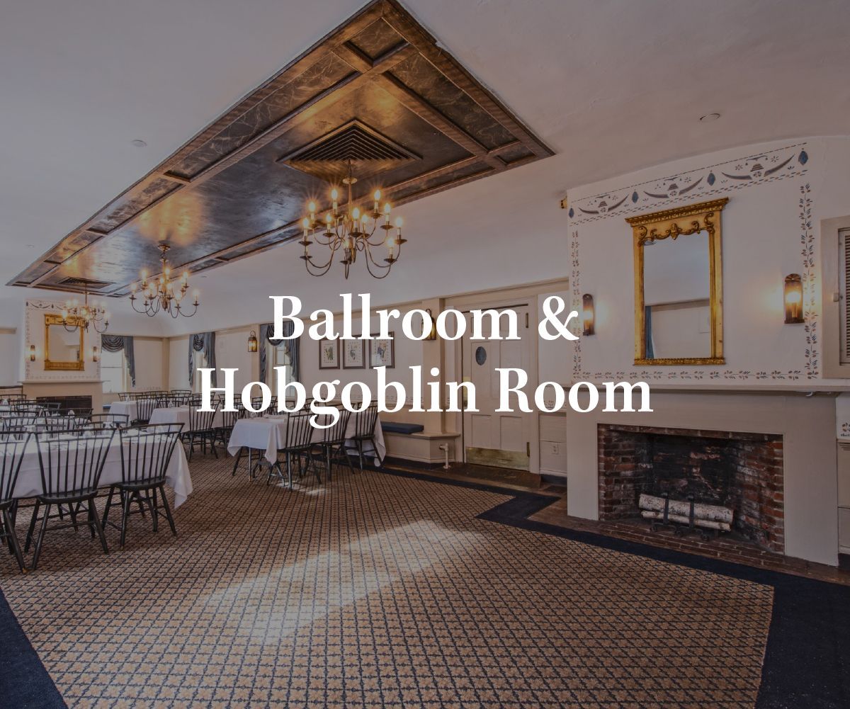 The Ballroom & Hobgoblin Room at a venue featuring chandeliers, tables with white linens, and a fireplace.