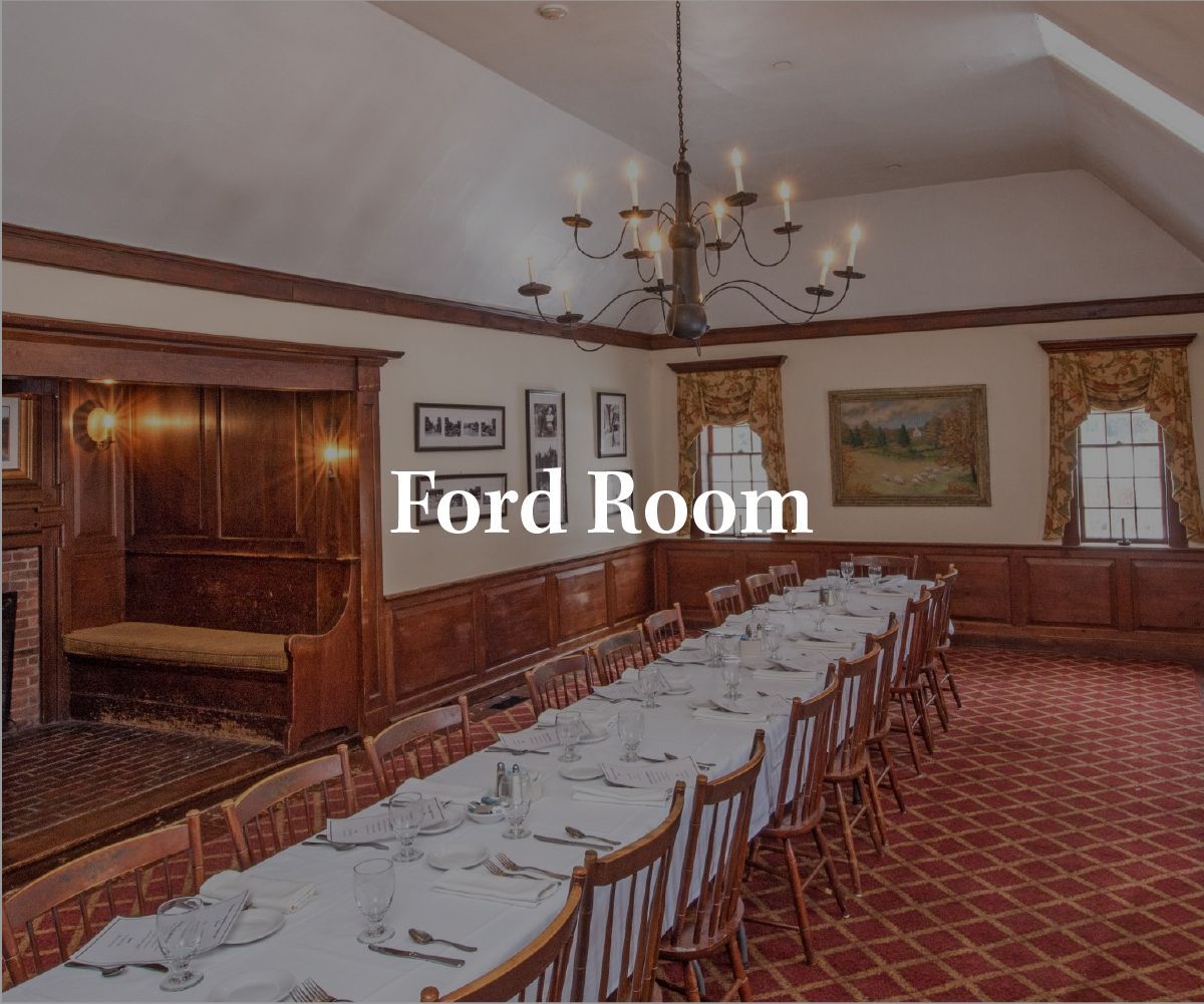 The Ford Room features a long banquet table set for dining, surrounded by wooden chairs under a chandelier in a hall.