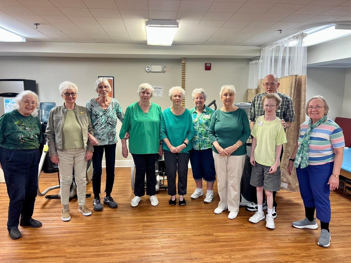 A group of elderly people posing for a picture in a room
