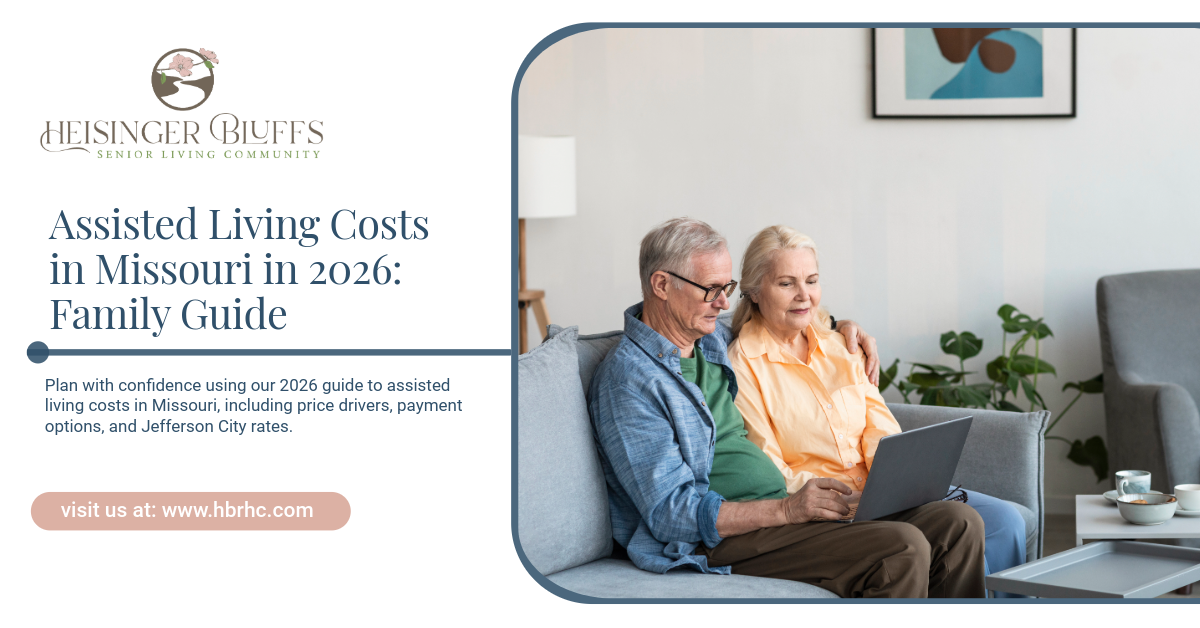 An elderly couple sitting on a couch, looking at a laptop