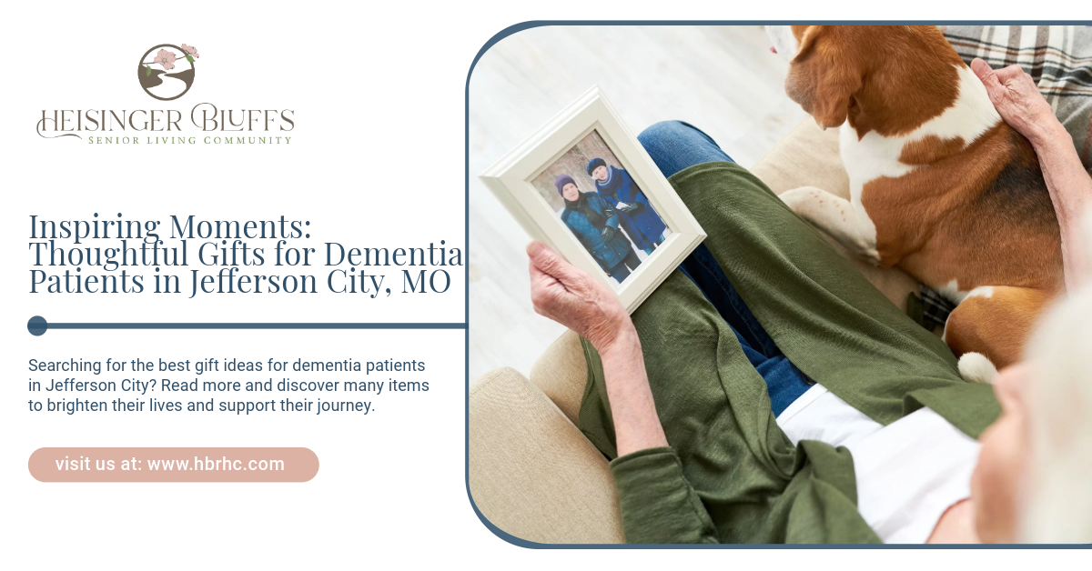A woman laying on a couch with a dog and holding a picture