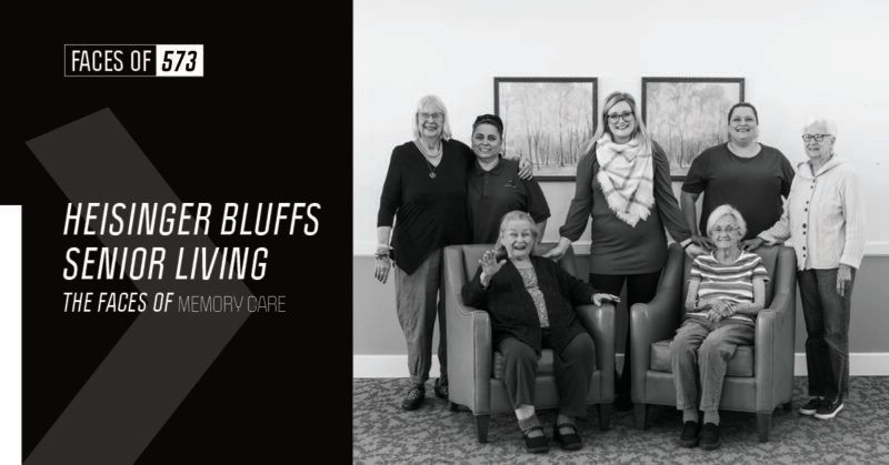 A black and white photo of a group of people sitting in chairs