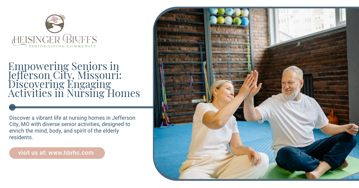 A man and a woman are giving each other a high five while sitting on a yoga mat.