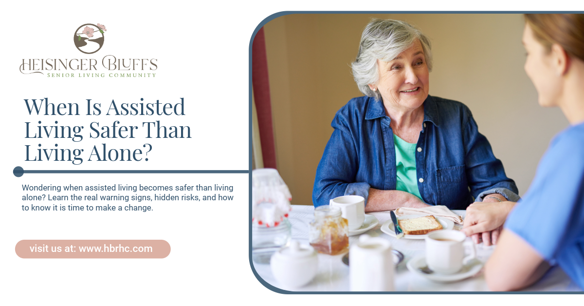 An assisted living resident eating breakfast with a staff member