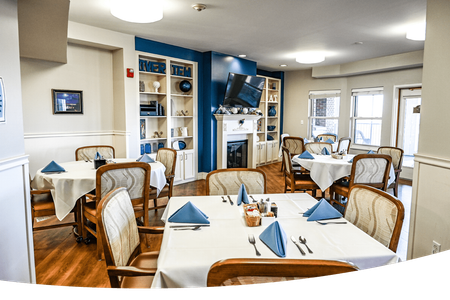 Assisted Living: Personalized Assisted Living at Heisinger Bluffs, Jefferson City, MO: Enhancing Daily Living with Dedicated Care. A large dining room with tables and chairs