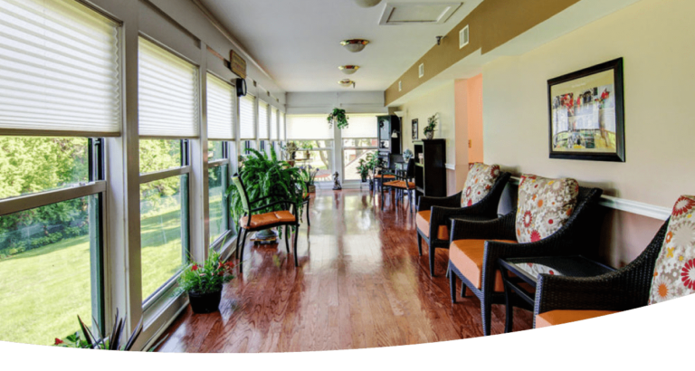 A long hallway with  windows and chairs