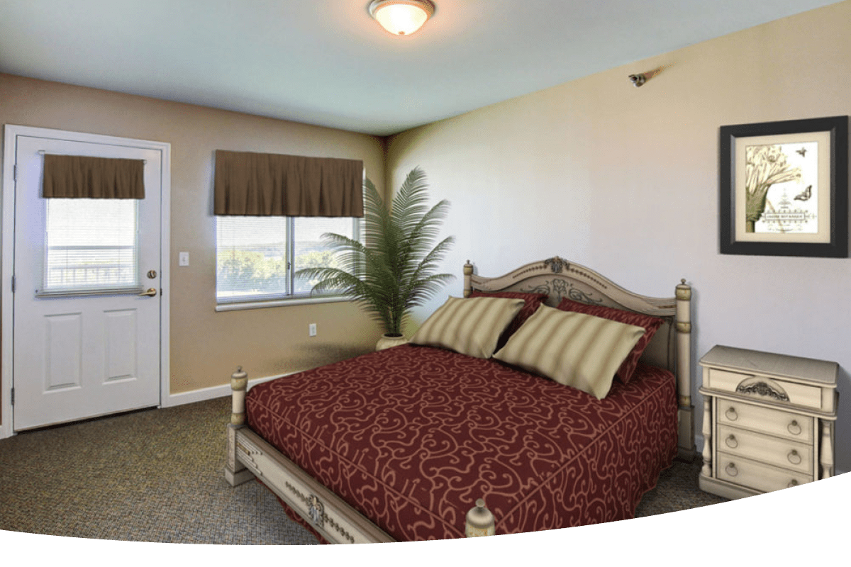 A bedroom with a bed, indoor plant, nightstand, and a picture on the wall
