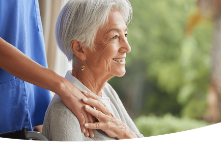Jefferson City Life Plans at Heisinger Bluffs - Independent Senior Living Community An elderly woman in a wheelchair being helped by a nurse