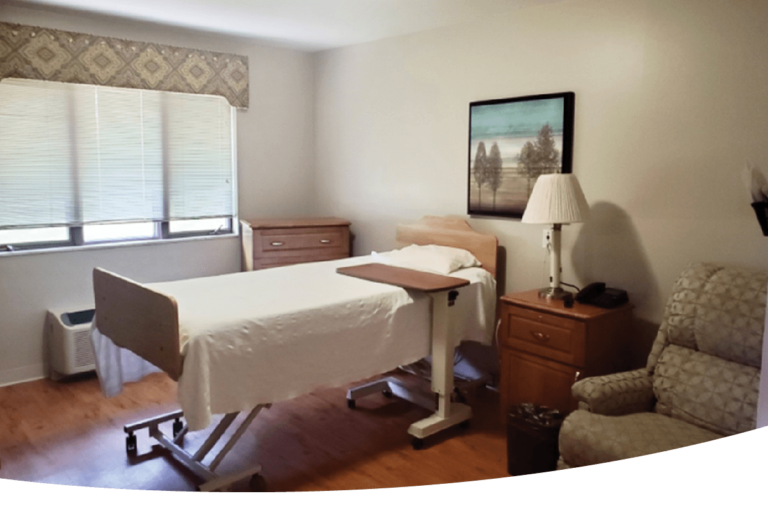 A hospital room with a bed and a chair