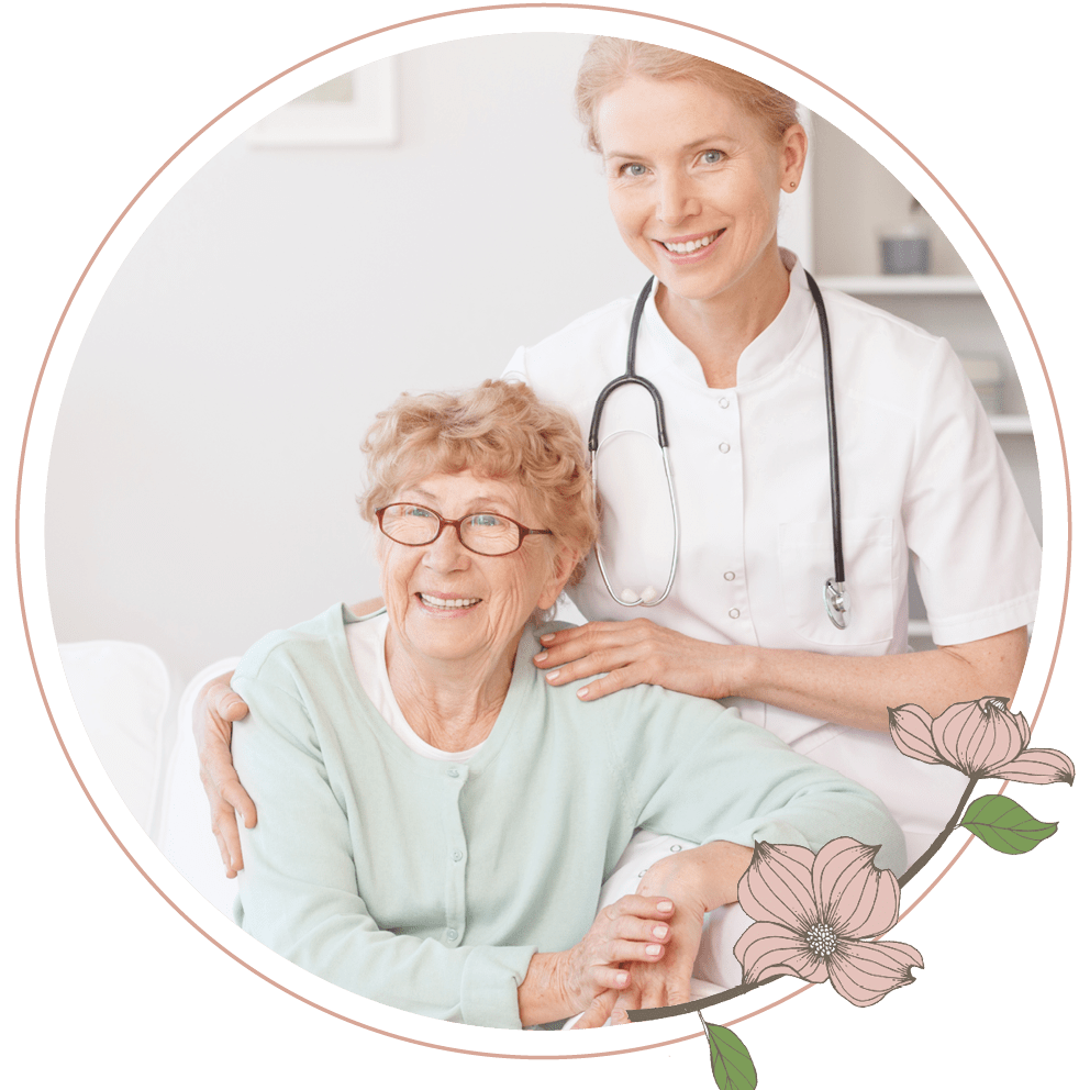 A nurse sitting next to an elderly woman on a couch