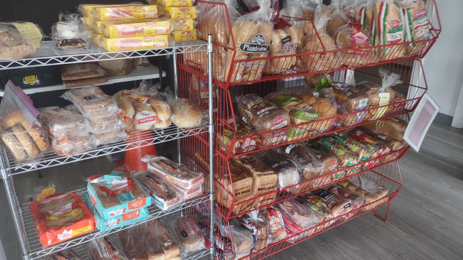There are many different types of bread on the shelves.