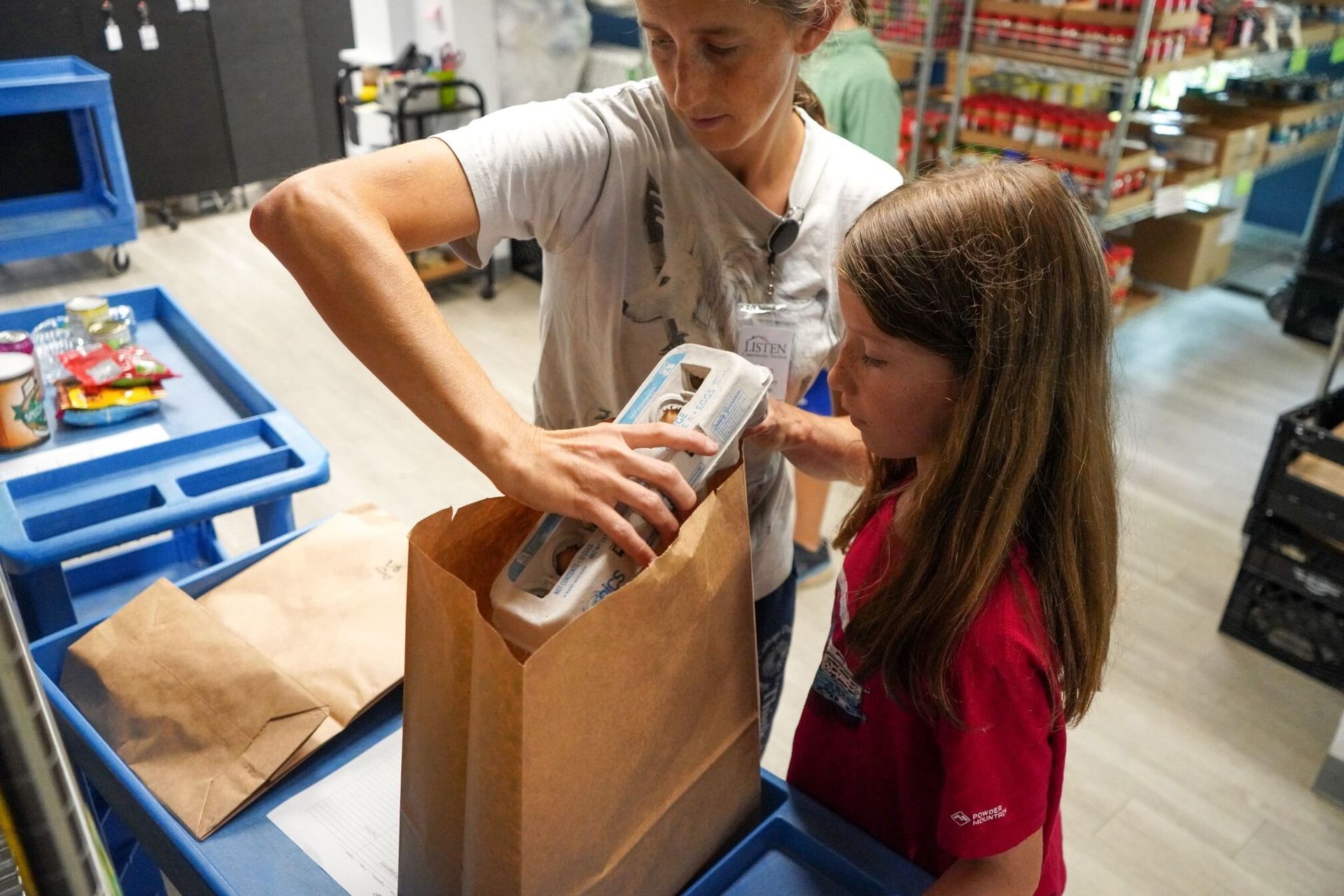 Two young girls are standing next to each other in a store.