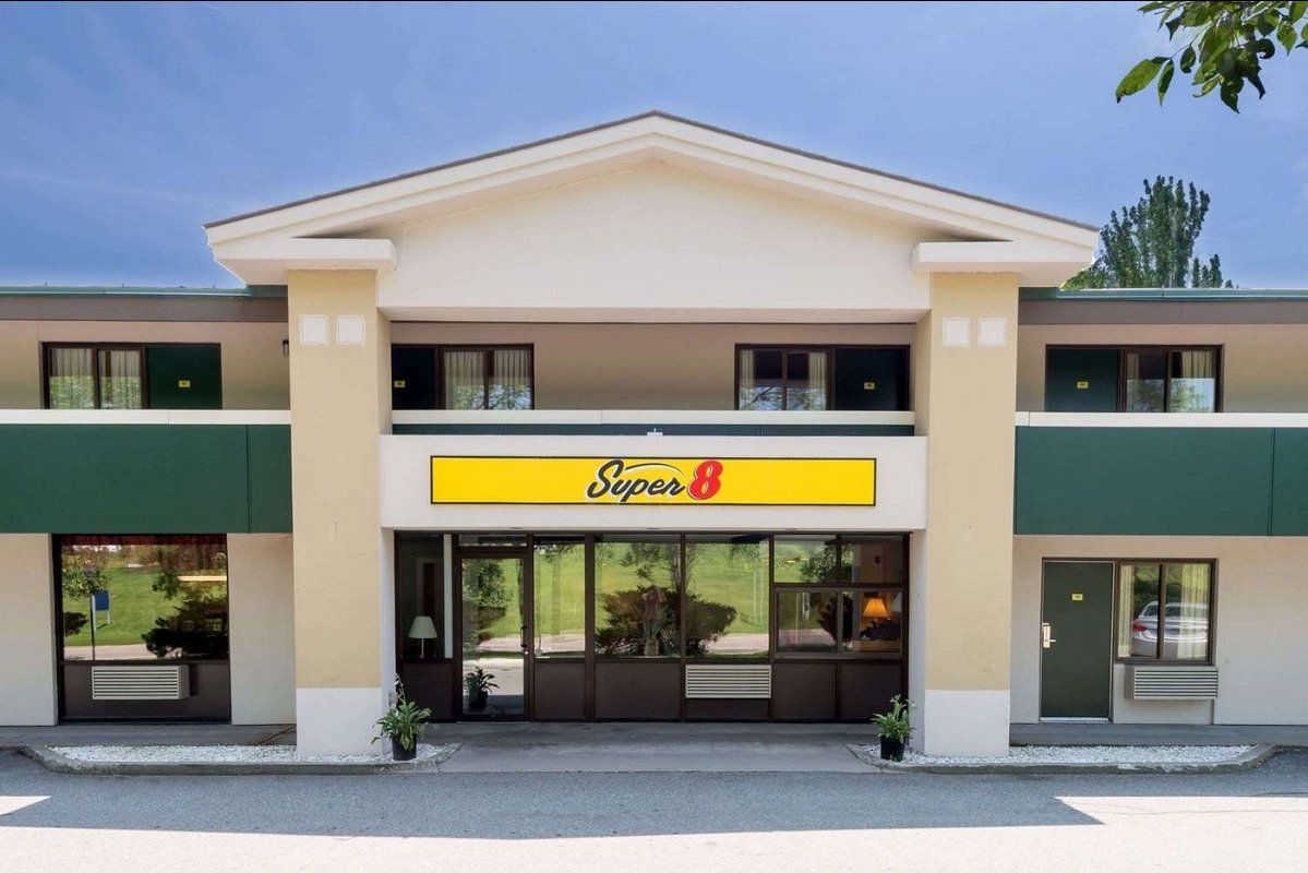 A large building with a yellow sign that says super 8