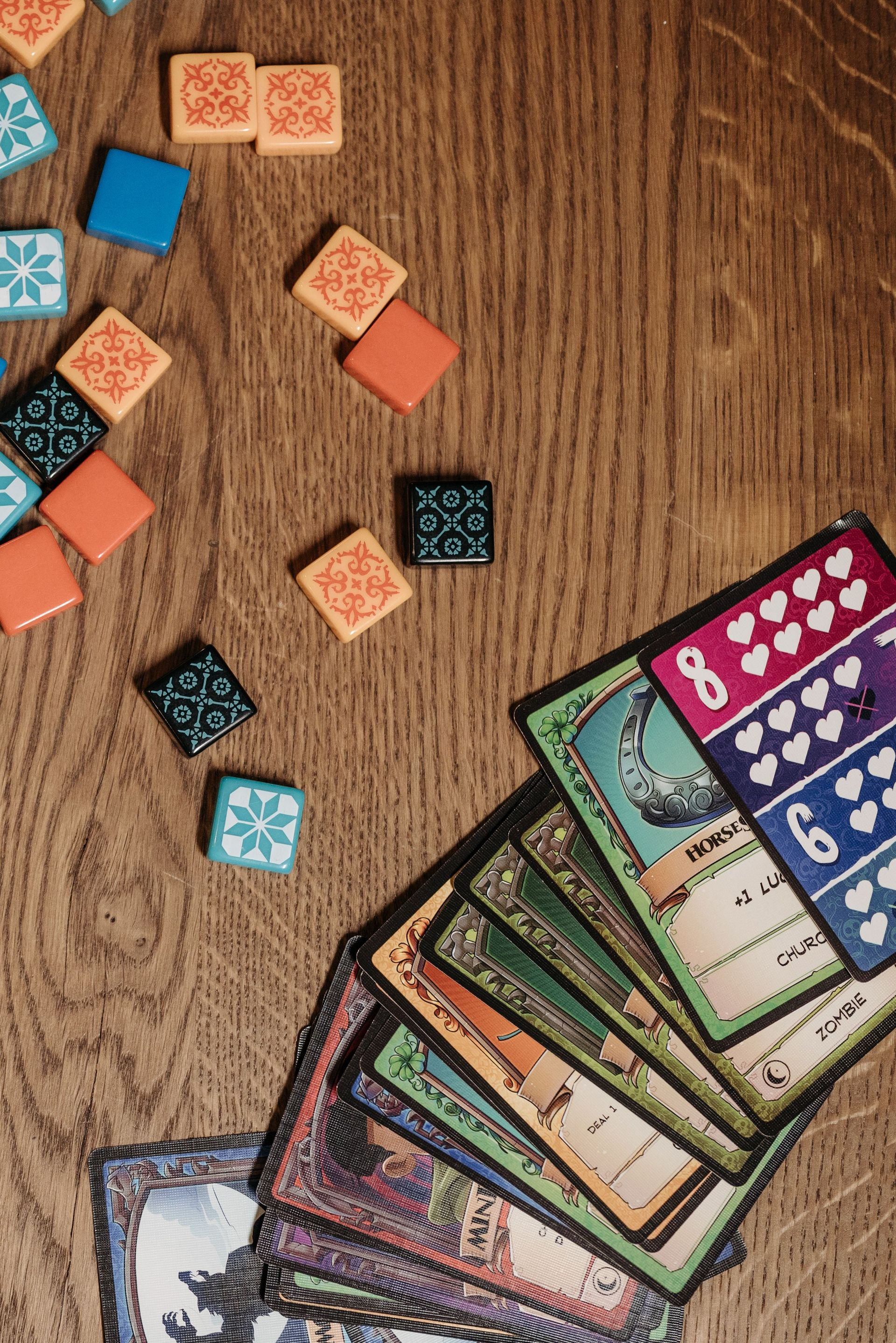 Kleurrijke spelpionnen op een blauw bord met cirkelvormige vakjes en verspreide kleine fiches.