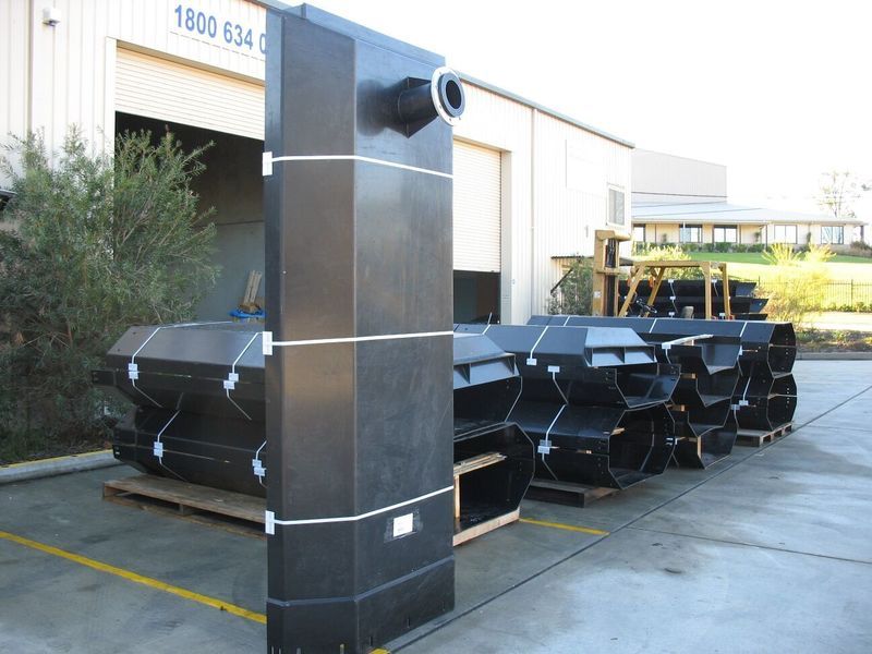 A large black object is sitting in front of a building with the number 1800 on it - Engineering Tooling In Thornton, NSW
