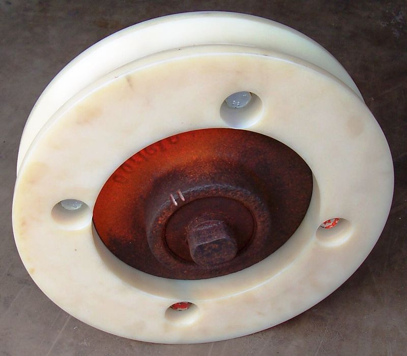A close up of a white wheel with holes in it - Engineering Tooling In Thornton, NSW