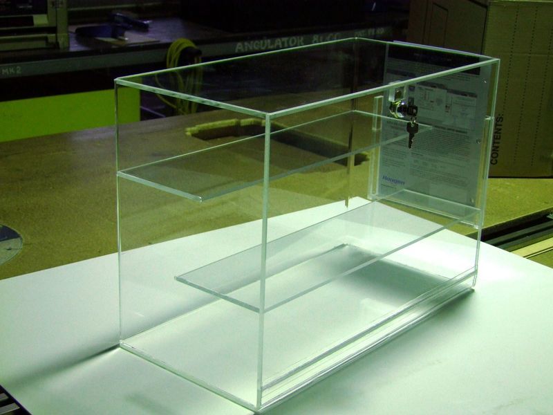 A clear acrylic box with two shelves sits on a table - Engineering Tooling In Thornton, NSW