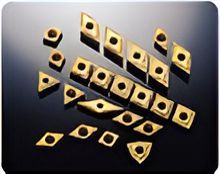 A bunch of gold pieces are sitting on top of each other on a black surface - Engineering Tooling In Thornton, NSW
