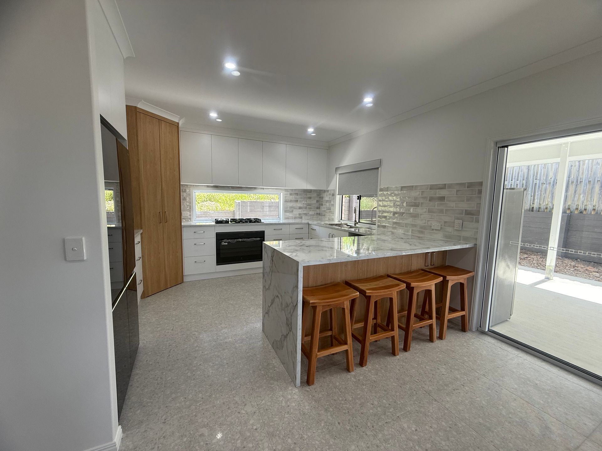 A Bathroom With Two Sinks and a Walk in Shower — Werry Building Services in Gladstone, QLD