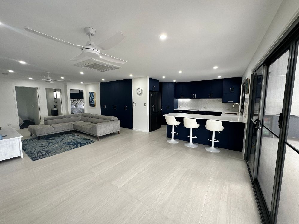 A Bathroom With a Walk in Shower With a Glass Door — Werry Building Services in Boyne Island, QLD
