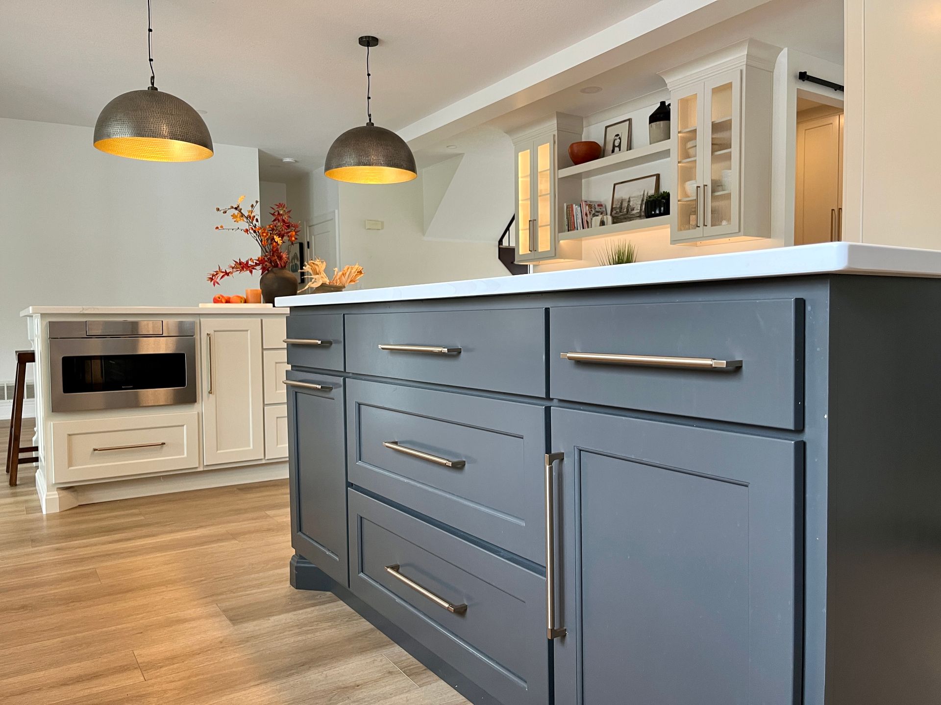 Island table with grey drawers and cabinets.