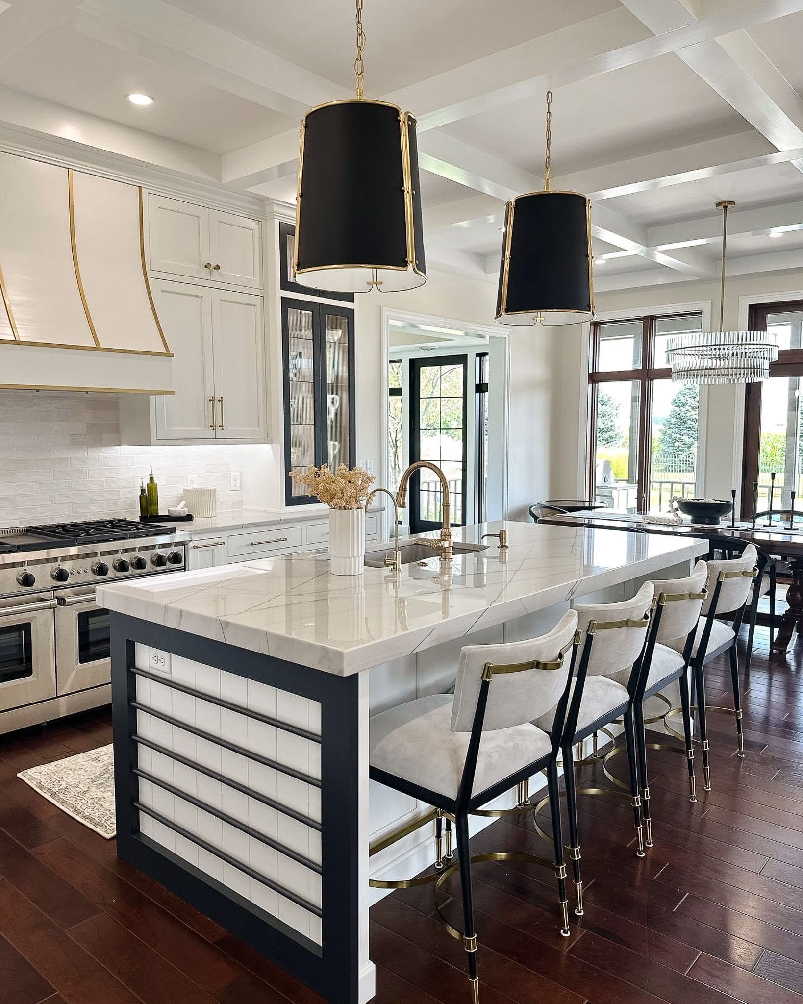 Island table with chairs set out and a sink visible on the table.