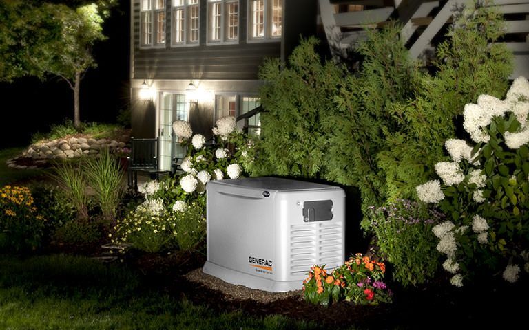 a generator is sitting in the backyard of a house .