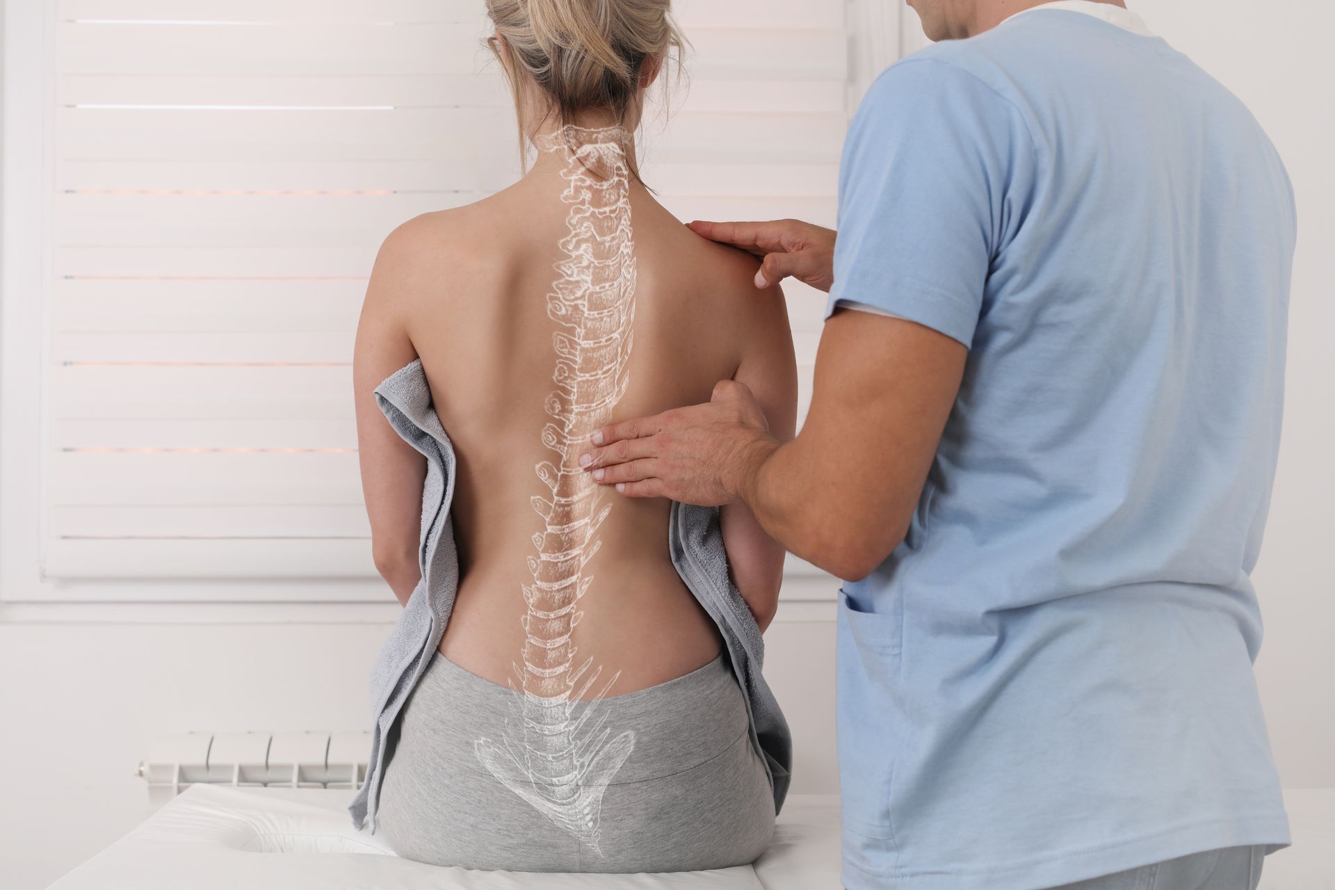 Doctor Checking Patient's Backache — Hastings, NE — Adams County Chiropractic