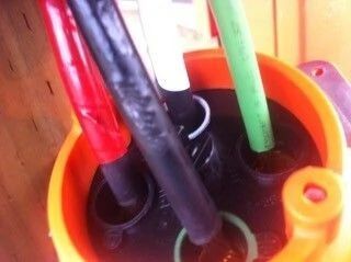 Colored cables inserted into an orange circular connector block close-up