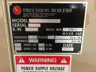 Boiler control plate with Precision Boilers label and warning sign about high voltage.