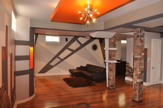 A living room with a couch and a chandelier on the ceiling