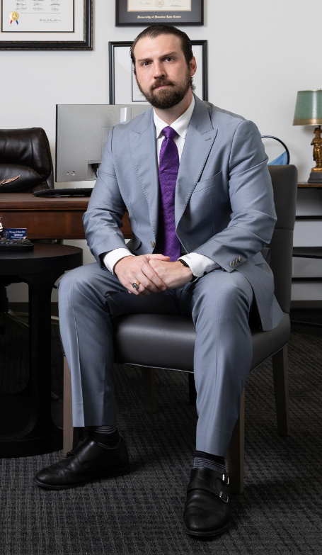 Theodore Hale sitting in a chair, wearing a suit