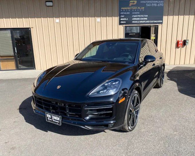 Black Porsche Cayenne with paint protected by expert PPF installation